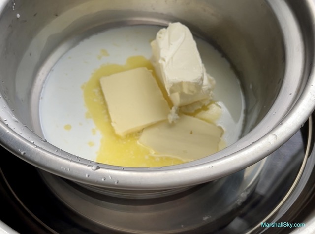 Marshall 輕乳酪蛋糕-將奶酪鍋置於煮沸熄火的熱水鍋上，間接加熱融化。